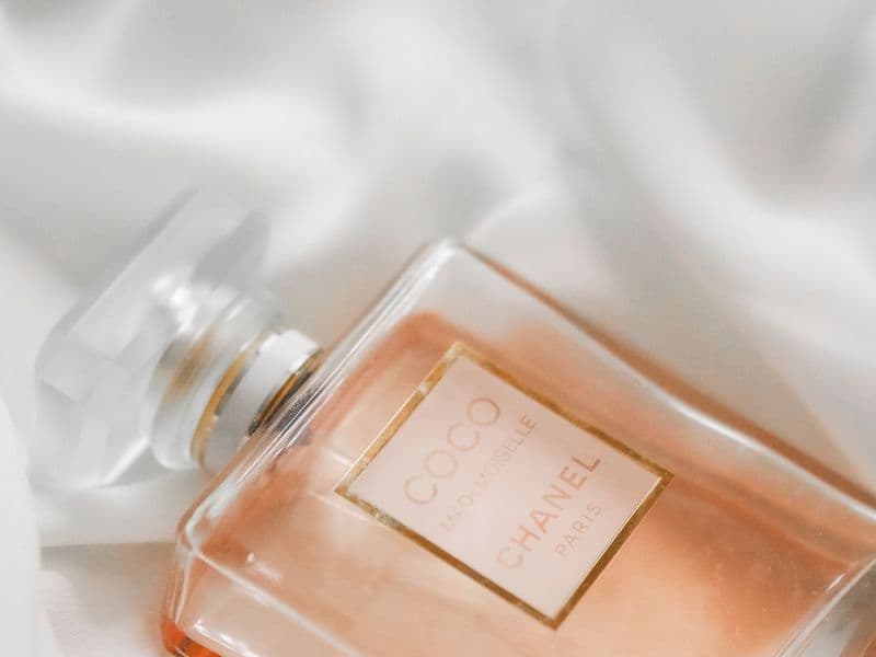 Product photo, perfume bottle on silk