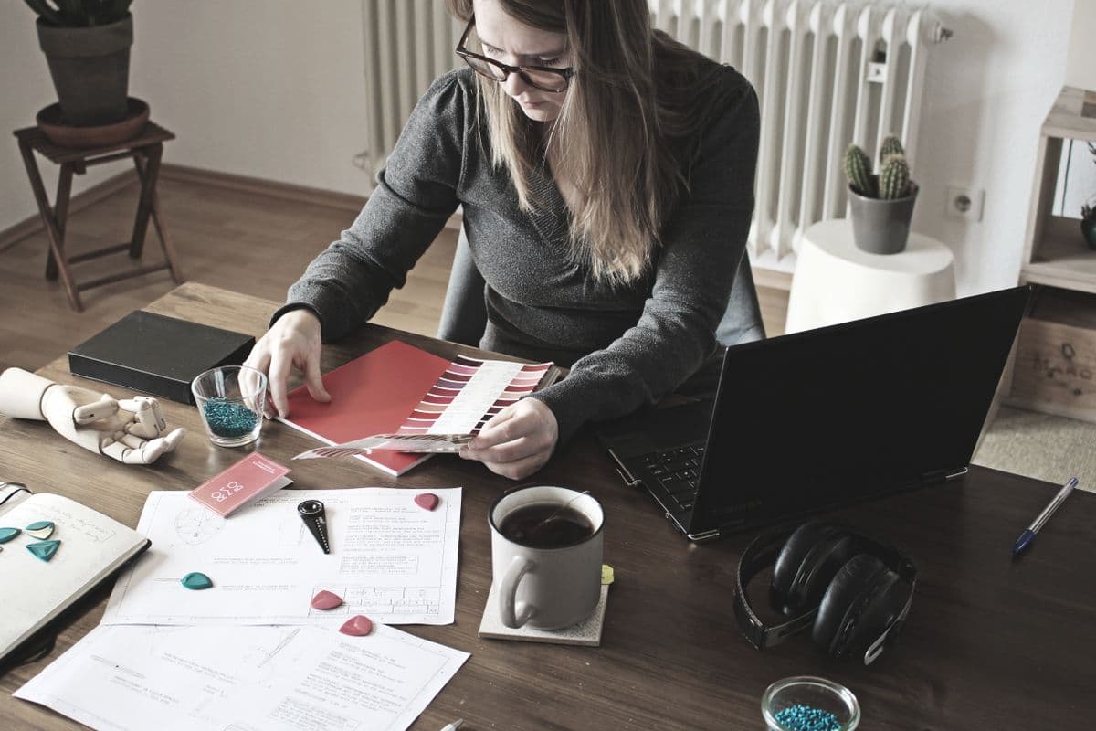 A designer reviewing layouts at a desk